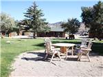 Chairs and table in the sand at YELLOWSTONE VALLEY INN & RV PARK - thumbnail