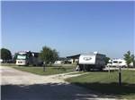 RV and travel trailer on grassy sites at BEYONDER GETAWAY AT LAZY ACRES - thumbnail