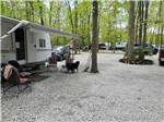 A gravel RV site with a trailer at AMERICAN WILDERNESS CAMPGROUND - thumbnail