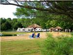 A pair of blue chairs on the beach at AMERICAN WILDERNESS CAMPGROUND - thumbnail
