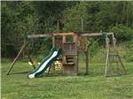 The wooden playground equipment at FROG CITY RV PARK - thumbnail