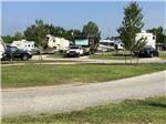 A grassy area next to an RV site at FROG CITY RV PARK - thumbnail