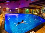A lady swimming in an indoor swimming pool at THE MILL CASINO HOTEL & RV PARK - thumbnail