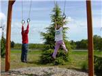 A couple of kids playing on the playground at TOUTLE RIVER RV RESORT - thumbnail
