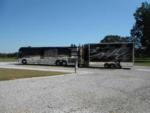 A motorhome pulling a trailer at HERITAGE ACRES RV PARK - thumbnail