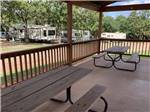 A pair of picnic benches on the deck at OAK GLEN RV PARK - thumbnail