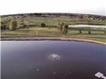 Aerial view of pond and golf course at BAILEY'S RV RESORT - thumbnail