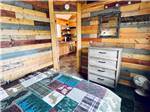 The bedroom and kitchen of the cabin at KLONDIKE RV PARK & COTTAGES - thumbnail