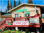 The office building with signage on the deck at KLONDIKE RV PARK & COTTAGES - thumbnail