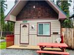 One of the cottage rentals with a bench at KLONDIKE RV PARK & COTTAGES - thumbnail