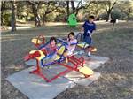 Kids playing on the playground equipment at BECS STORE & RV PARK - thumbnail
