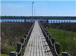The wooden pathway going to the water at WHITE OAK SHORES CAMPING & RV RESORT - thumbnail