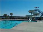 The swimming pool with a large slide at WHITE OAK SHORES CAMPING & RV RESORT - thumbnail