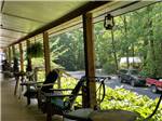 The covered porch on the office with chairs at SOLITUDE POINTE CABINS & RV PARK - thumbnail