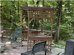 A swinging bench next to a fire pit at SOLITUDE POINTE CABINS & RV PARK - thumbnail