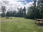 Picnic chairs in grassy area at CAMPING POKEMOUCHE - thumbnail