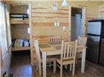 Dining area and bunk beds in cabin at CAMPING POKEMOUCHE - thumbnail