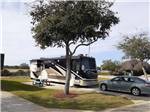 A motorhome in a back in paved RV site at GERONIMO RV PARK - thumbnail