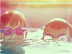 Two kids spending time in the pool at JETSTREAM RV RESORT PEARLAND - thumbnail