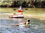 Kids floating in inner tubes on the river at CEDAR CREEK RV & OUTDOOR CENTER - thumbnail