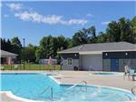 Swimming pool and hot tub under sunny sky at MADISON VINES RV RESORT & COTTAGES - thumbnail