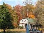 Barn-shaped building amid an autumn landscape at MADISON VINES RV RESORT & COTTAGES - thumbnail