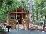 Park model in cabin design with front porch at MADISON VINES RV RESORT & COTTAGES - thumbnail