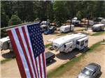 An aerial view of the campsites with an American flag at CROSS WINDS FAMILY CAMPGROUND - thumbnail