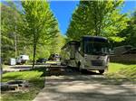 A motorhome in a paved RV site at WOOD'S TALL TIMBER RESORT - thumbnail