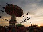 The swing ride at sunset nearby at EXPO CENTER RV PARK - thumbnail