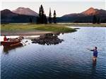 A man fly fishing in the water at EXPO CENTER RV PARK - thumbnail