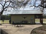 Cabin with outdoor seating area at COFFEE CREEK RV RESORT & CABINS - thumbnail