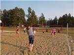 Campers playing volleyball at RAFTER J BAR RANCH CAMPING RESORT - thumbnail