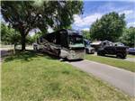 A motorhome in a pull thru RV site at TRAVELERS CAMPGROUND - thumbnail