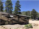 A large motorhome with it's awning out at FLAGSTAFF RV PARK - thumbnail
