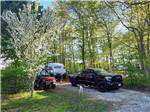 A black truck and trailer in a gravel site at HTR DOOR COUNTY - thumbnail