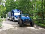 A Jeep and trailer in a deluxe pull thru site at HTR DOOR COUNTY - thumbnail