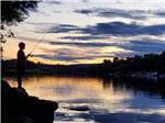 A boy fishing in the morning at SID TURCOTTE PARK CAMPING AND COTTAGE RESORT - thumbnail