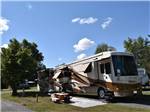 A motorhome in a gravel RV site at CAMP HITHER HILLS - thumbnail
