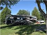 A large fifth wheel trailer in an RV site at CAMP HITHER HILLS - thumbnail