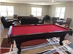 A red pool table and sitting area at FLORIDA CAVERNS RV RESORT AT MERRITT'S MILL POND - thumbnail