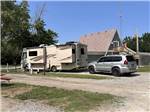 A motorhome and a SUV parked in a pull thru site at ALL SEASONS RV PARK - thumbnail