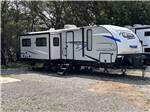 A travel trailer parked in a back in site at ALL SEASONS RV PARK - thumbnail