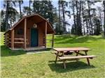 A cabin with a bench at THREE BEARS FAMILY CAMPING & RV PARK - thumbnail