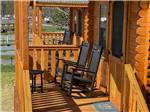 Chairs on porch of rental cabin at HERSHEY ROAD CAMPGROUND - thumbnail