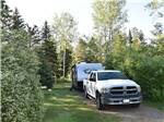 A truck and trailer in a gravel site at HAPPY LAND RV PARK - thumbnail