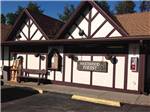 General Store with a bench and firewood in front at SHERWOOD FOREST CAMPING & RV PARK - thumbnail