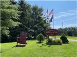 The front entrance sign with flags at SCOTIA PINE CAMPGROUND - thumbnail