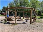 A circle of swinging benches and a fire pit at SCOTIA PINE CAMPGROUND - thumbnail