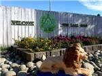 Sign leading into campground resort with lion statue in front at SAC-WEST RV PARK AND CAMPGROUND - thumbnail